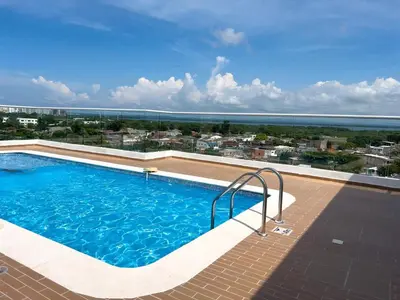a swimming pool with a view of the ocean at 2 cuartos AC y piscina in Cartagena de Indias