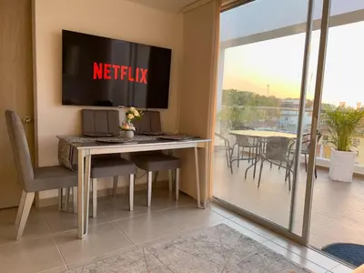 a living room with a television on the wall at 2 cuartos terraza piscina AC in Cartagena de Indias