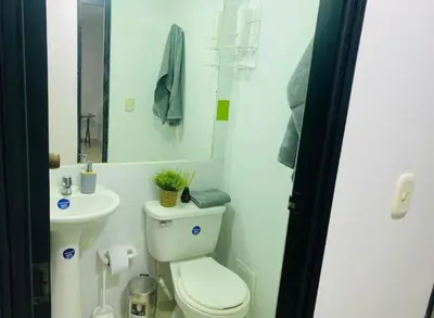a small bathroom with a toilet and a sink at Apartamento en Barranquilla in Barranquilla