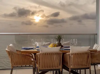 a dining room table with chairs and a view of the ocean at Luxury Ocean View Apartment Building H2 - Hyatt in Cartagena de Indias
