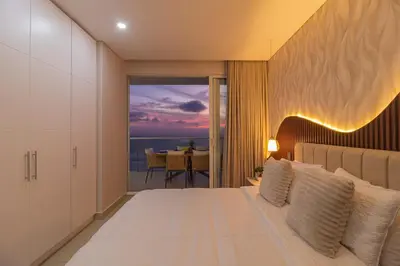 a bedroom with a bed with a view of the ocean at Luxury Ocean View Apartment Building H2 - Hyatt in Cartagena de Indias