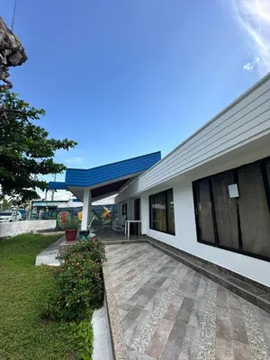 a white building with a blue roof at Casa Blanca in Coveñas