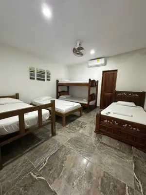 a room with three bunk beds in it at Casa Blanca in Coveñas