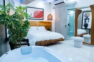 a bedroom with a bed and a bath tub at Luxury Apartment BayView Jacuzzi Guestfriendly in Cartagena de Indias