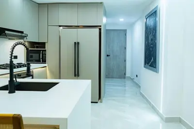 a kitchen with a refrigerator and a white counter top at Luxury Apartment BayView Jacuzzi Guestfriendly in Cartagena de Indias