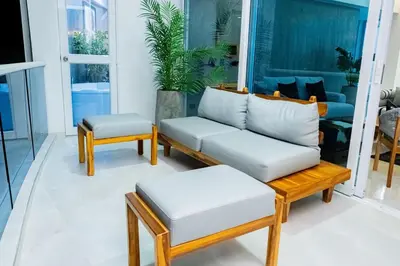 a couch and stool in a living room at Luxury Apartment BayView Jacuzzi Guestfriendly in Cartagena de Indias