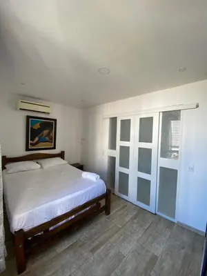 a bedroom with a large bed and a window at Departamento con vista al mar in Cartagena de Indias