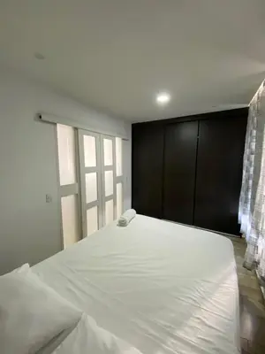 a bedroom with a large white bed and a window at Departamento con vista al mar in Cartagena de Indias