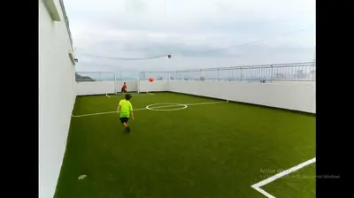 a young boy playing a game of soccer on a roof at Departamento con vista al mar in Cartagena de Indias