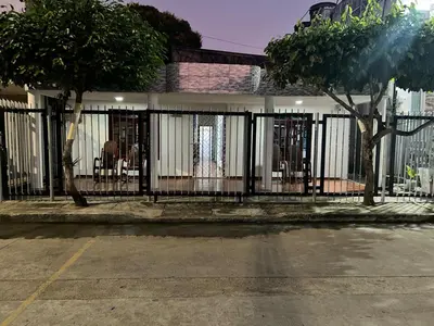 a house with a gate in front of a street at Cabañas villa Ángela in Coveñas