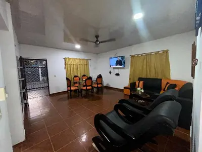 a living room with couches and a table and chairs at Cabañas villa Ángela in Coveñas