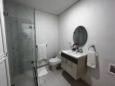a bathroom with a shower and a toilet and a sink at Apt luxury wifi AC pool at Cartagena in Cartagena de Indias