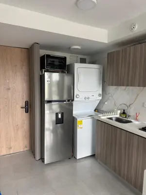 a kitchen with a stainless steel refrigerator and a microwave at Apto refugio del mar in Cartagena de Indias