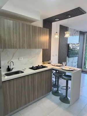 a kitchen with a counter and stools in it at Apto refugio del mar in Cartagena de Indias