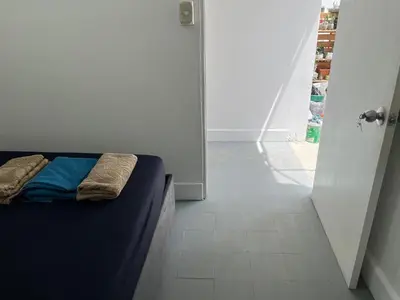 a bedroom with a bed and a hallway with a door at Habitación cerca a la playa 205 in Cartagena de Indias