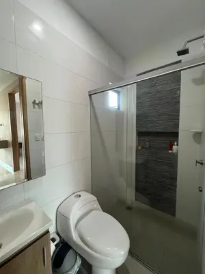 a bathroom with a toilet and a glass shower at Apto Caribe Mar in Coveñas