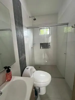 a bathroom with a white toilet and a sink at Apto Caribe Mar in Coveñas