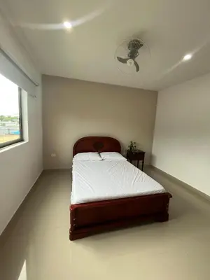 a bedroom with a bed in a room with a fan at Apto Caribe Mar in Coveñas