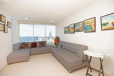 a living room with a couch and a table at Riviera Beach - Apartamento con vista al mar in Cartagena de Indias
