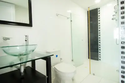 a bathroom with a glass sink and a toilet at Riviera Beach - Apartamento con vista al mar in Cartagena de Indias