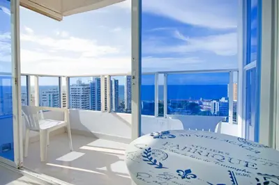 a balcony with a bed and a view of the city at Riviera Beach - Apartamento con vista al mar in Cartagena de Indias