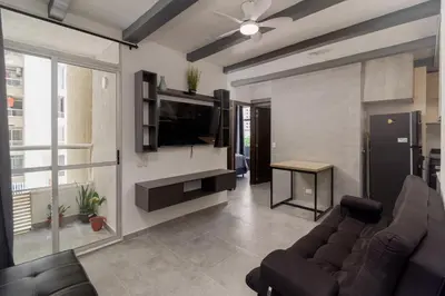 a living room with a couch and a television at Apt luxury near sea wifi Ac pool at Cartagena in Cartagena de Indias
