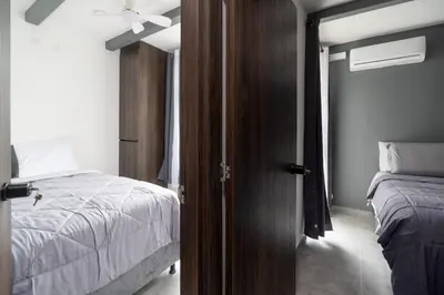 a bedroom with a bed and a door leading to a bedroom at Apt luxury near sea wifi Ac pool at Cartagena in Cartagena de Indias