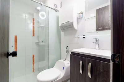 a bathroom with a toilet and a sink and a shower at Apt luxury near sea wifi Ac pool at Cartagena in Cartagena de Indias