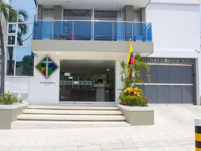 a building with a flag in front of it at Hotel Catedral inn B SAS in Barranquilla