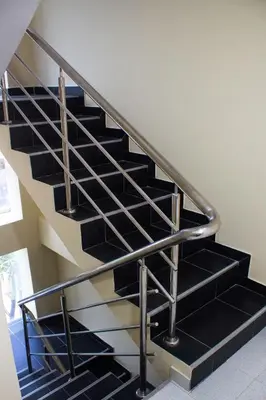a metal staircase with black treads in a house at Hotel Catedral inn B SAS in Barranquilla