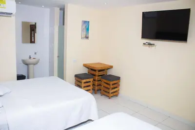 a room with a bed and a flat screen tv at Hotel Catedral inn B SAS in Barranquilla