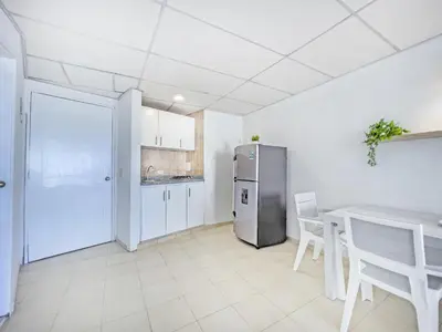 a kitchen with a stainless steel refrigerator and a table at Riviera Summer - Apartamento con balcón in Cartagena de Indias