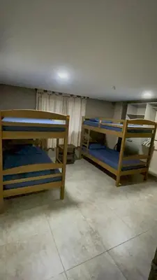 a room with two bunk beds in a room at Cabaña Belmar House in Puerto Salgar