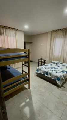 a bedroom with two bunk beds in a room at Cabaña Belmar House in Puerto Salgar