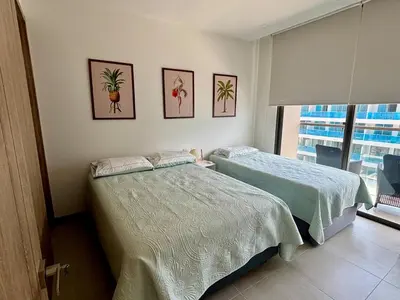a bedroom with two beds and a window at Beachfront Stay Morros EOS in Cartagena de Indias