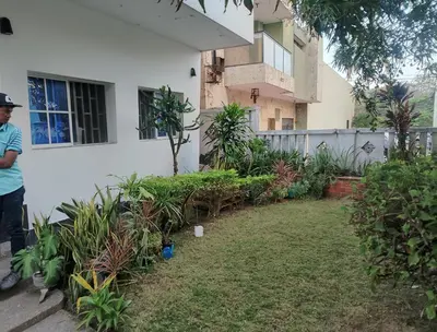a man standing in front of a house at Apartamento de lujo alto prado in Barranquilla