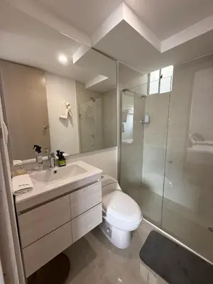 a bathroom with a toilet and a sink and a shower at Luxury Apartments in Barranquilla
