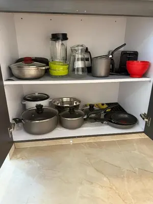 a shelf filled with pots and pans in a kitchen at Luxury Apartments in Barranquilla