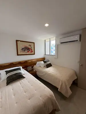 a bedroom with two beds and a window at Luxury Apartments in Barranquilla
