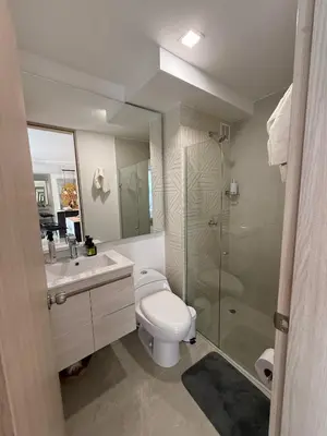a bathroom with a toilet and a sink and a shower at Luxury Apartments in Barranquilla