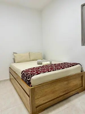 a bed with a wooden frame in a room at Casa Murillo Toro in Cartagena de Indias
