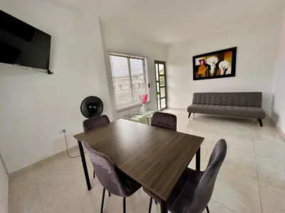 a dining room with a table and chairs and a couch at Casa Murillo Toro in Cartagena de Indias