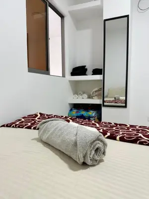 a towel laying on a bed in a room with mirrors at Casa Murillo Toro in Cartagena de Indias