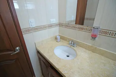 a bathroom with a sink and a mirror at Alojamiento en Torres del Lago in Cartagena de Indias