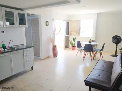 a kitchen and living room with a couch and a table at alojamiento frente mar 11 in Cartagena de Indias