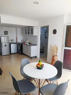 a room with a table and chairs and a kitchen at alojamiento frente mar 11 in Cartagena de Indias