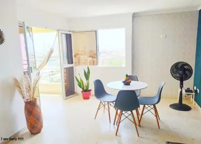 a dining room with a table and chairs and a window at alojamiento frente mar 11 in Cartagena de Indias