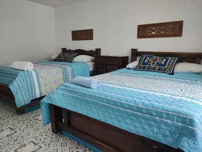a bedroom with two beds with blue comforters at Bogavante Getsemani para familias in Cartagena de Indias