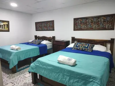 a room with two beds with towels on them at Bogavante Getsemani para familias in Cartagena de Indias