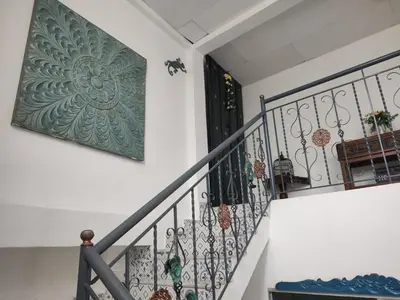 a stairway with a wrought iron railing and a door at Acantilado getsemani recomendado para familias in Cartagena de Indias